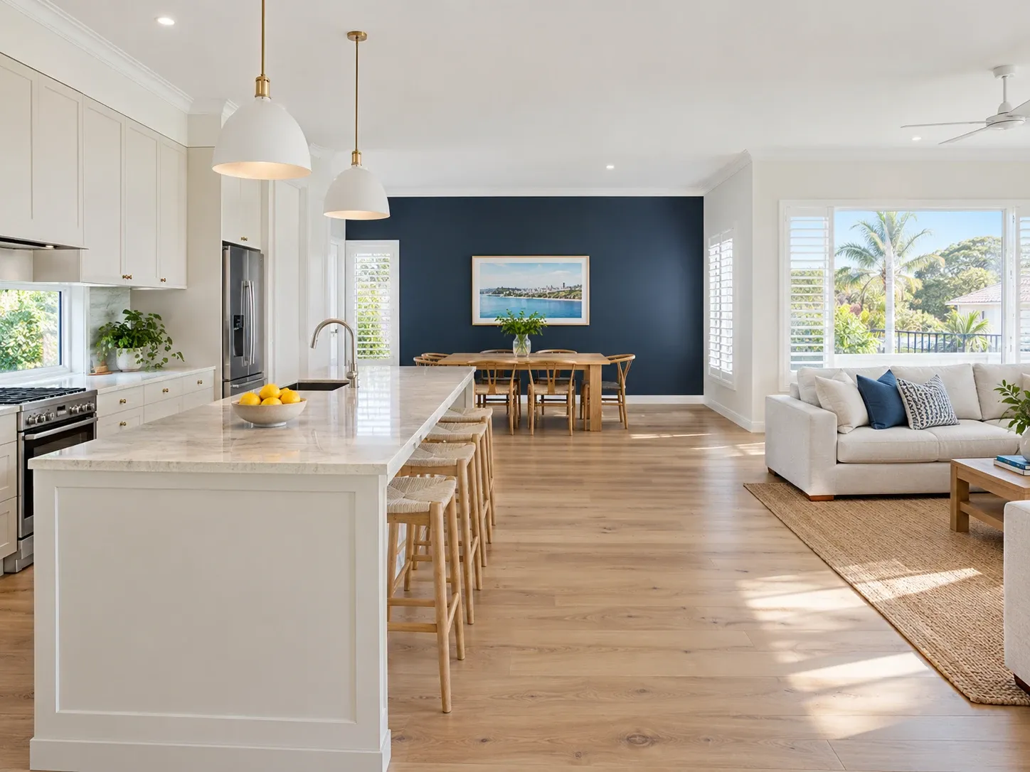 A bright open-plan living area with a navy feature wall